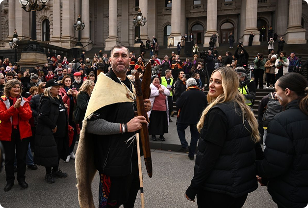 Travis Lovett arrives at Parliament House alongside his wife to finish the Walk for Truth.