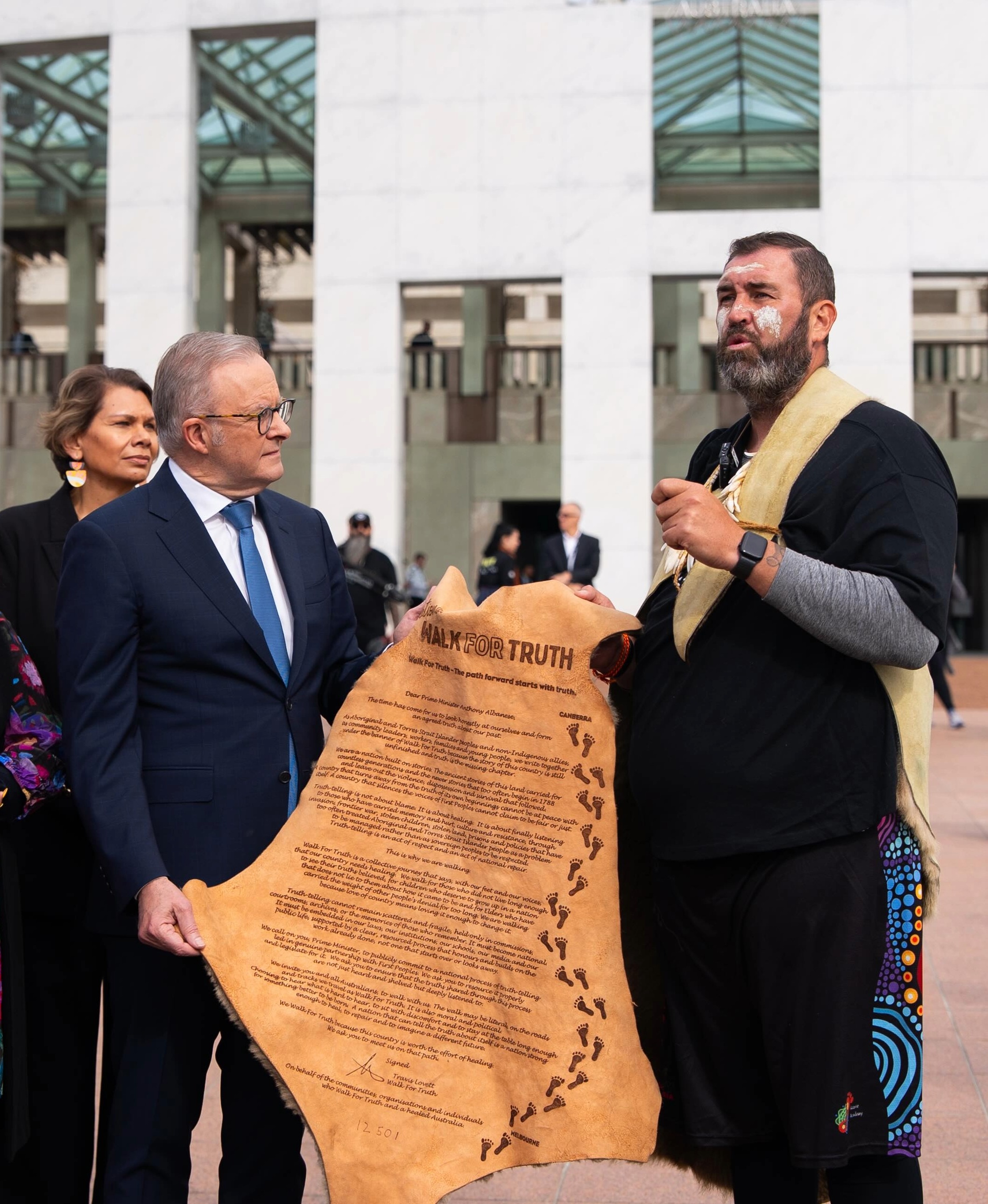 Travis Lovett presenting the Walk for Truth message to Prime Minister Anthony Albanese outside Parliament House.